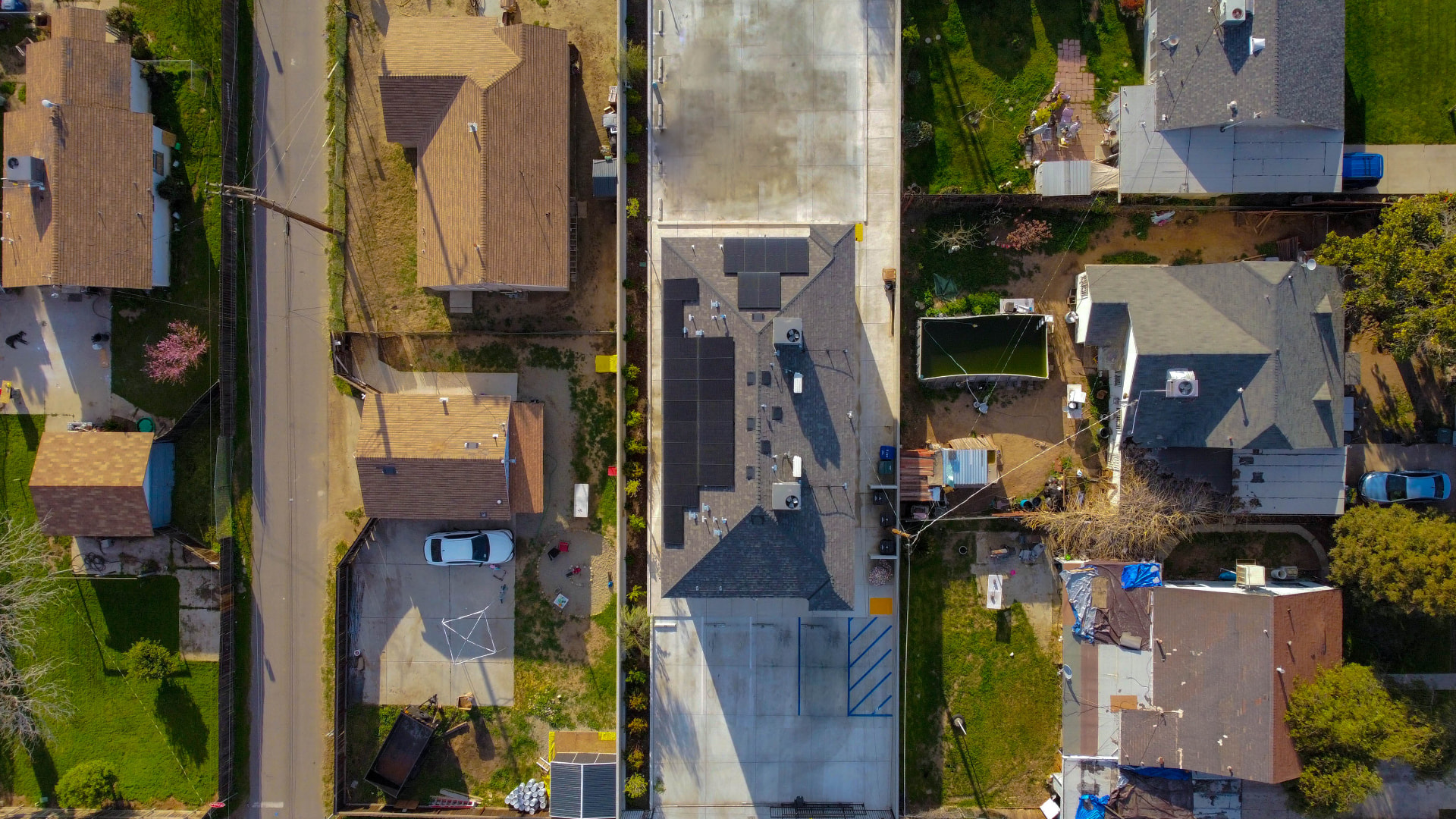 Vertical top-down aerial of the home, lot, and street