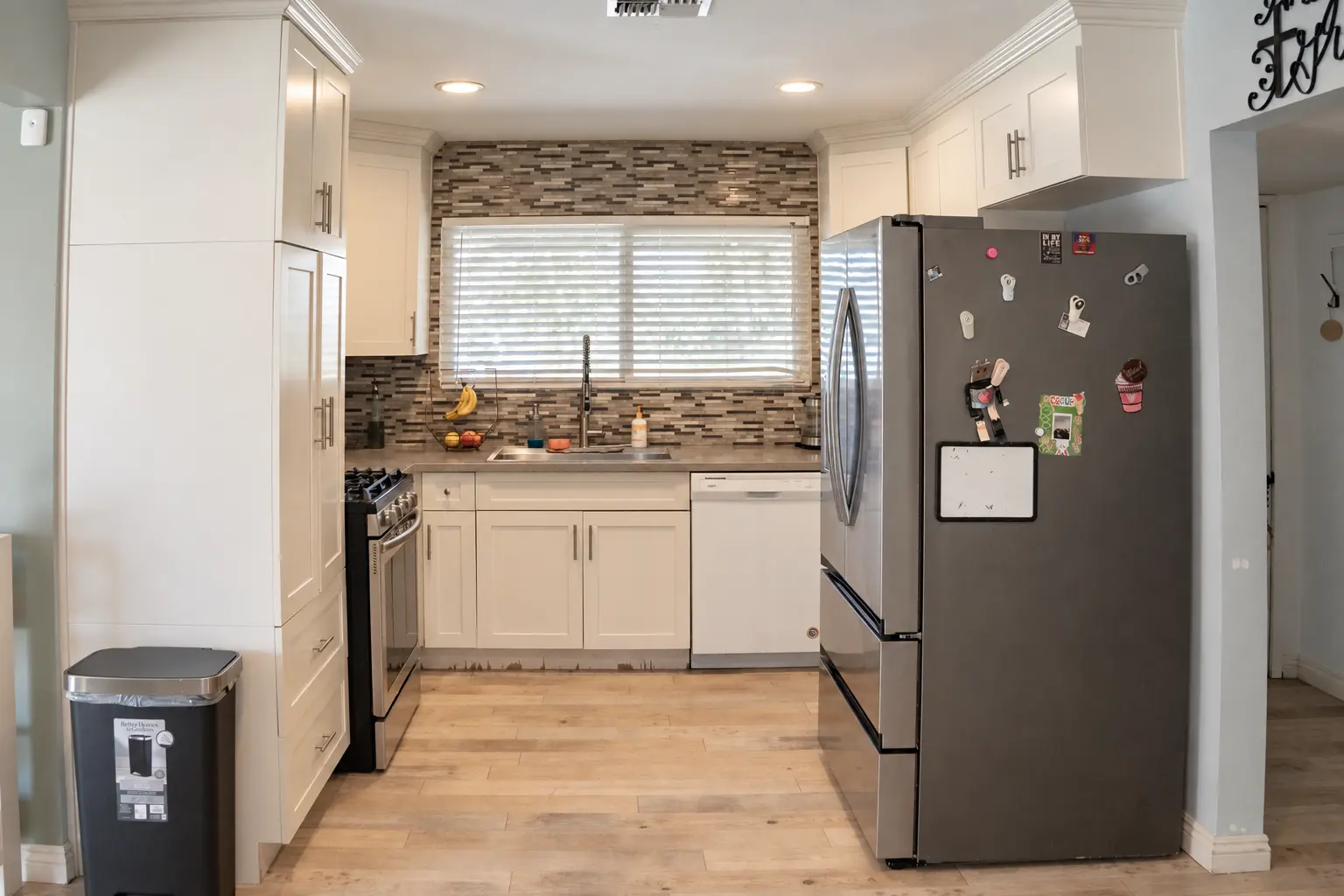 Kitchen with stainless appliances and tile backsplash
