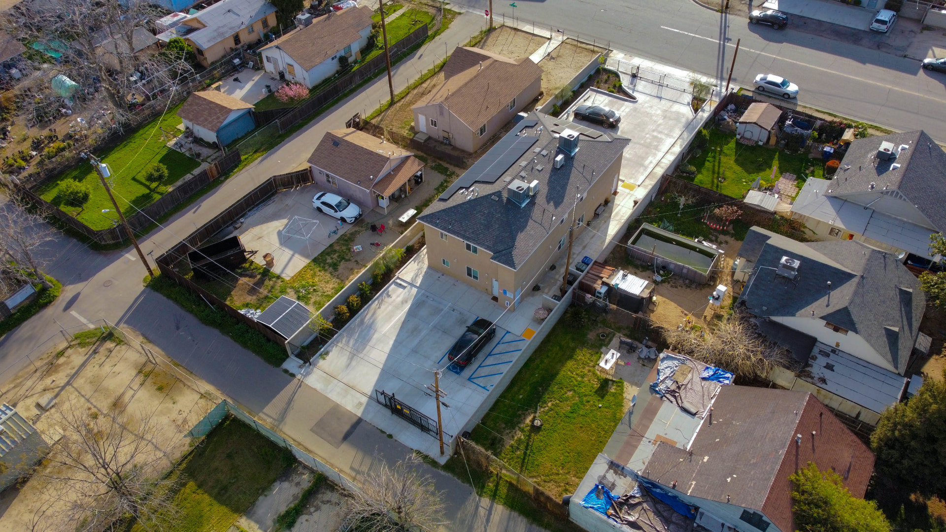 Angled aerial across the property and neighboring homes