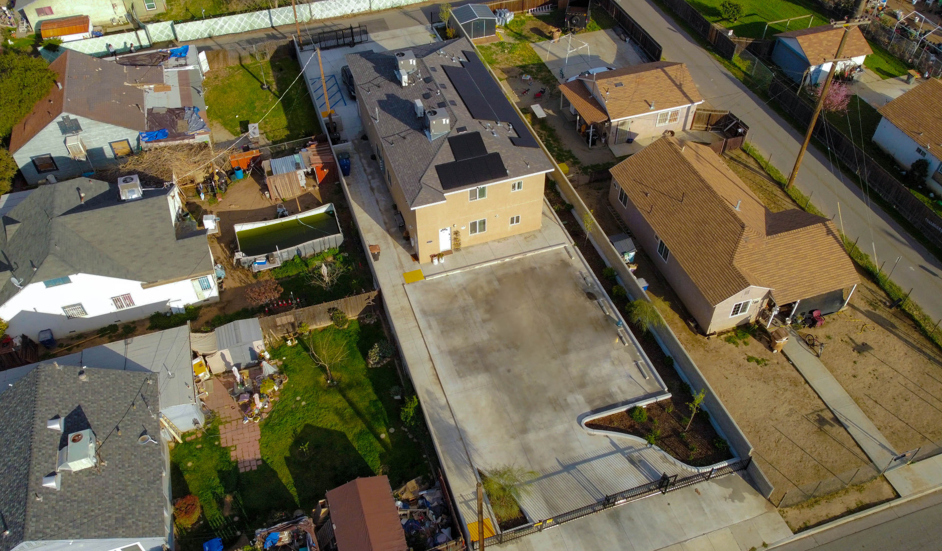 Angled aerial over the property and neighboring views