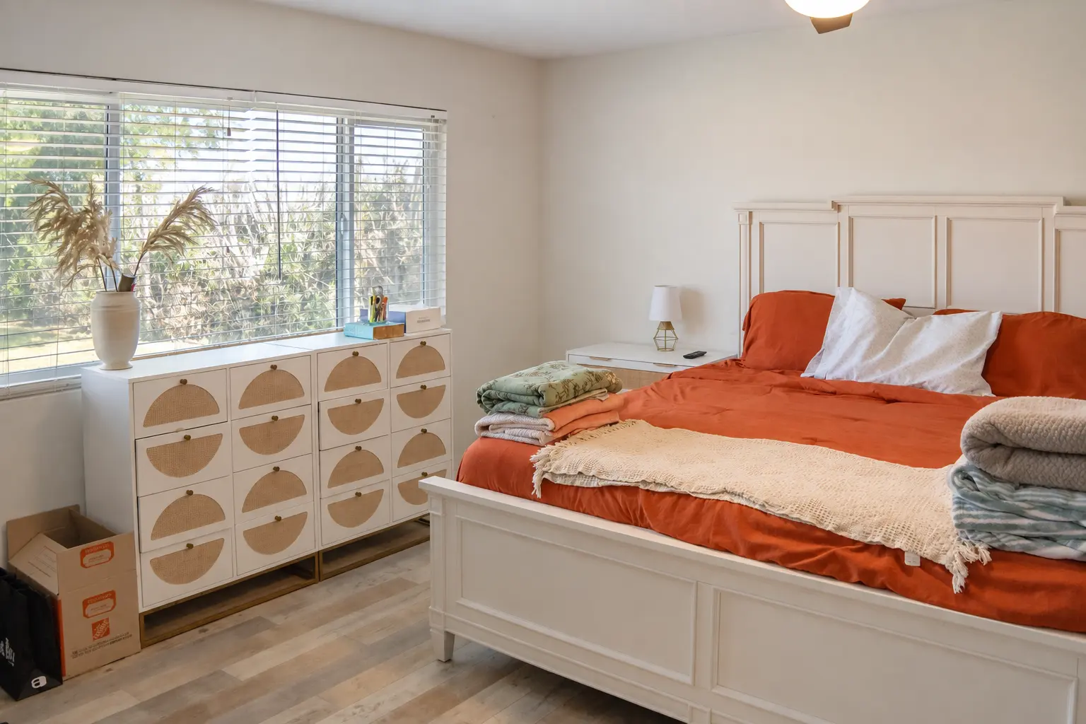 Primary bedroom with natural light and linens